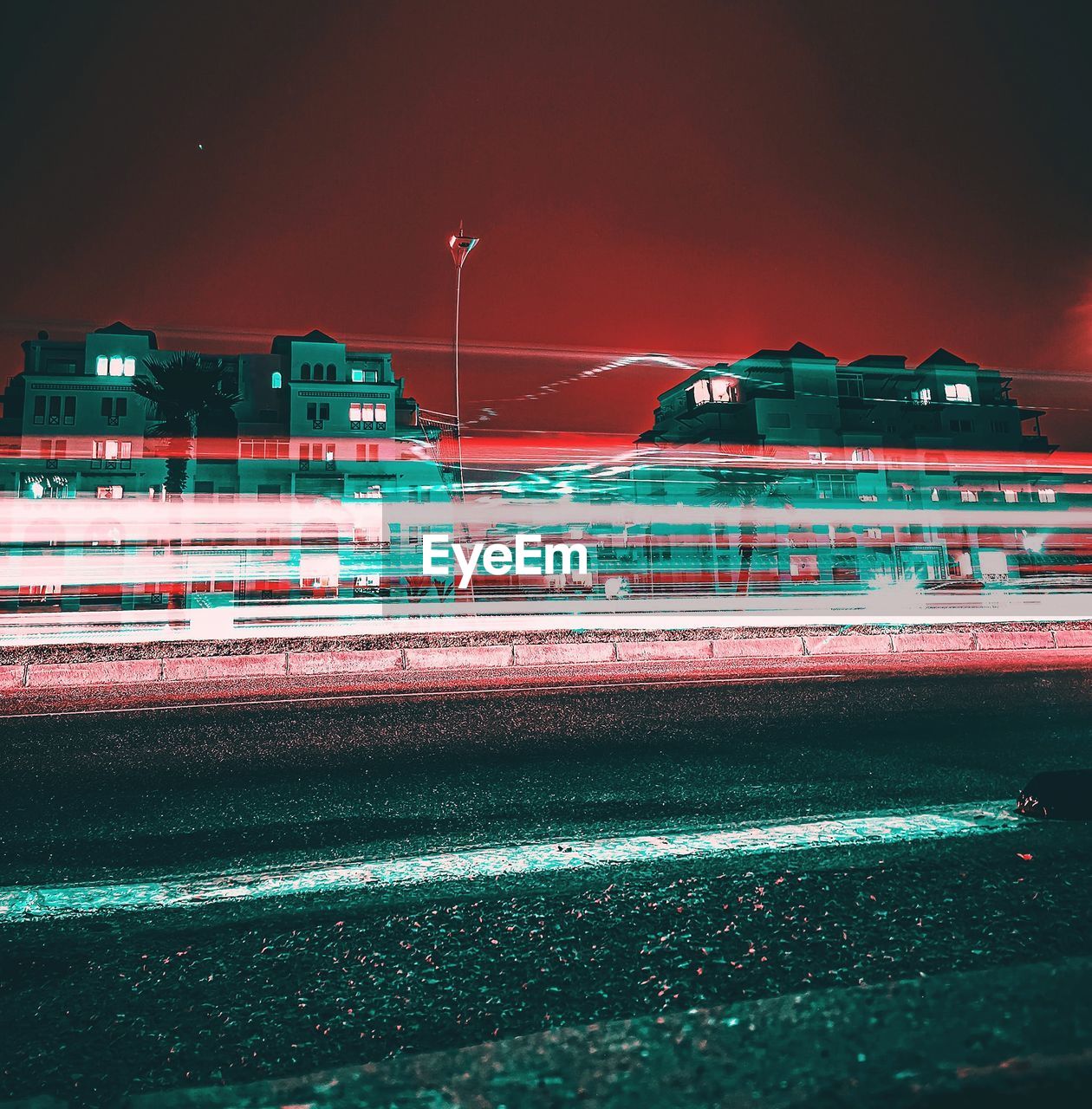 Light trails on road against buildings at night