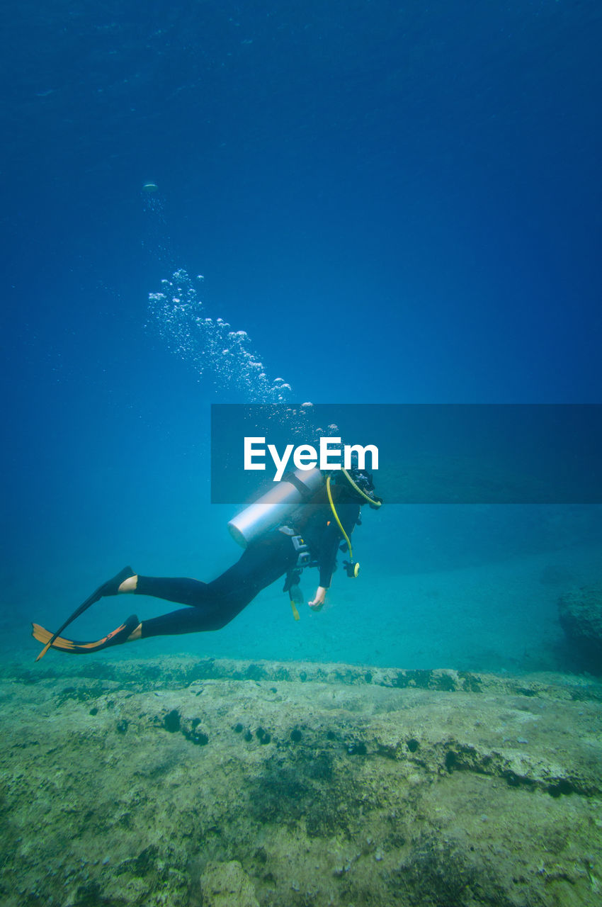 Woman scuba diving in sea