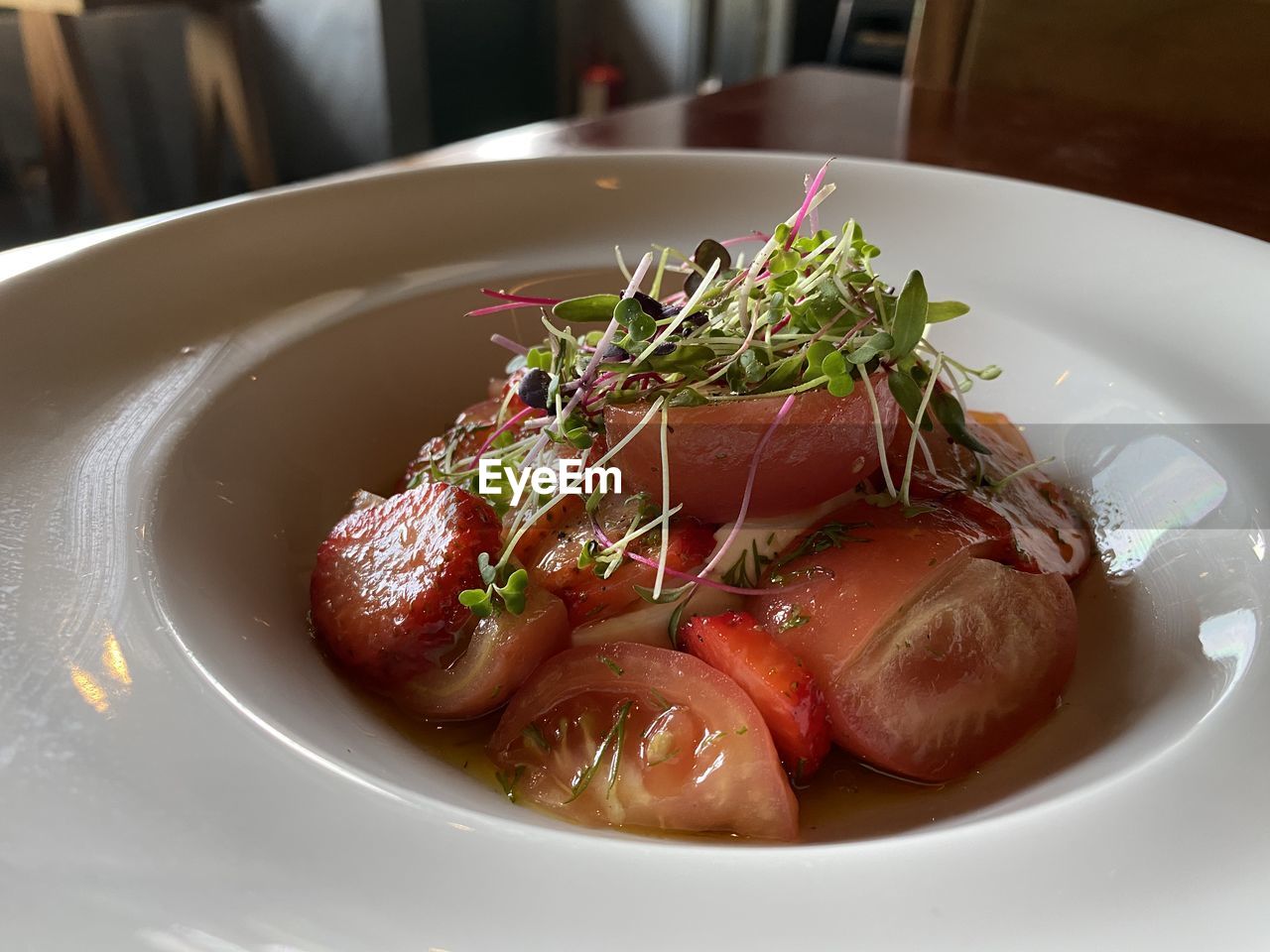 High angle view of tomato and strawberries salad served in plate