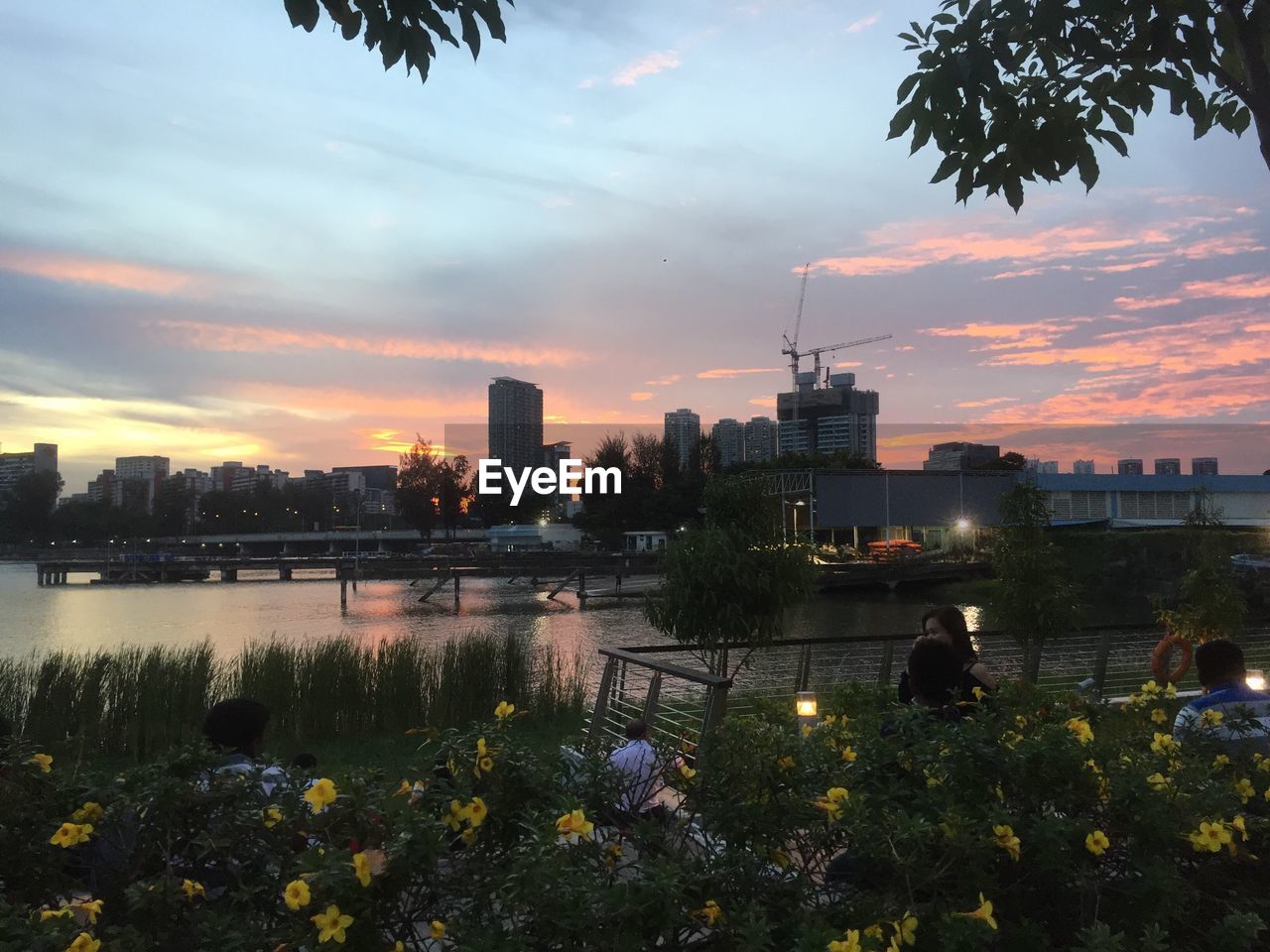 View of city at waterfront during sunset