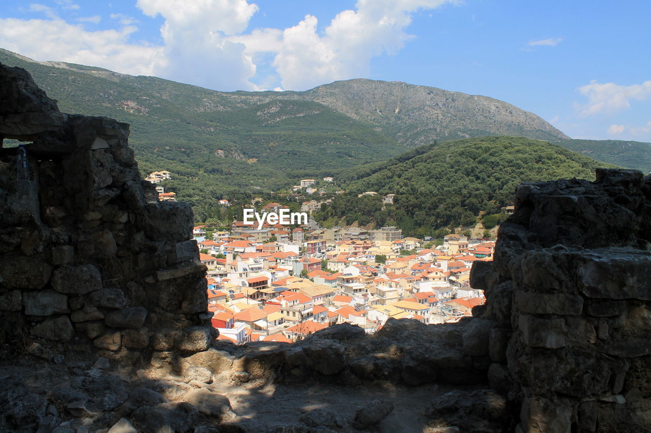 High angle view of town against forest mountain