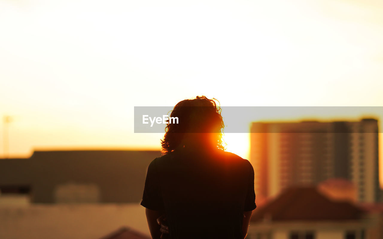 Silhouette man standing against sky during sunset