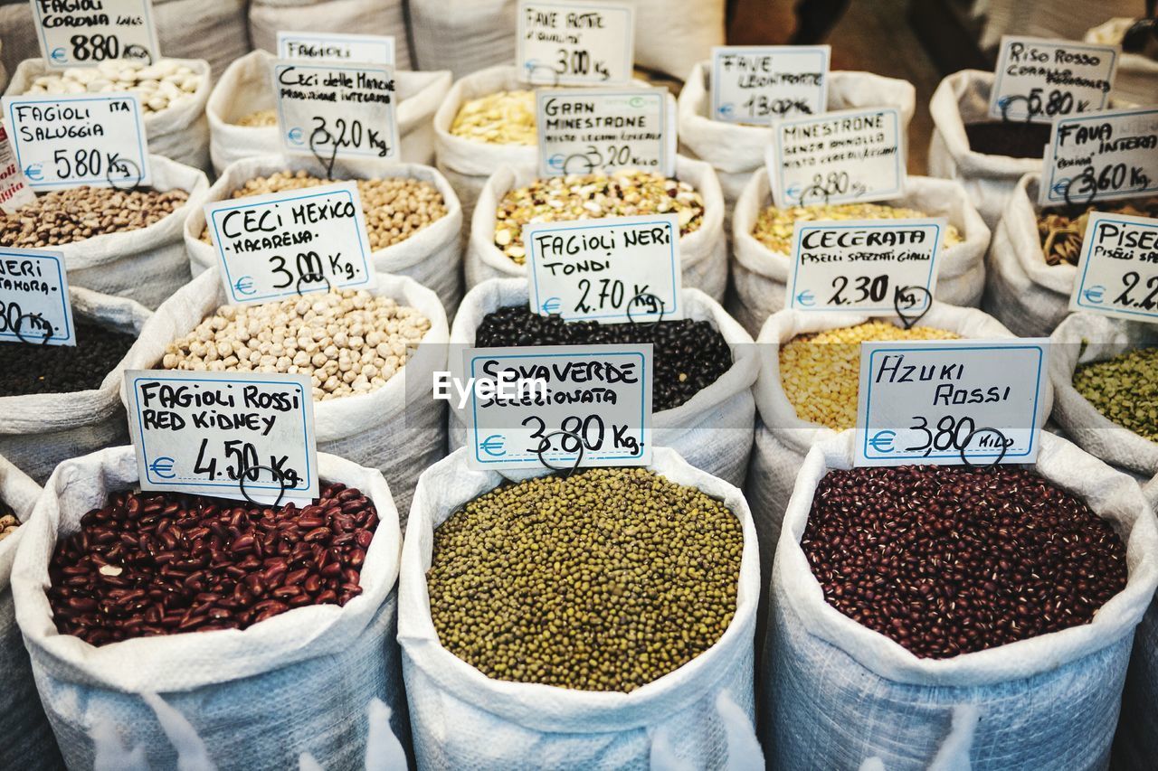 High angle view of various pulses with price tag at store