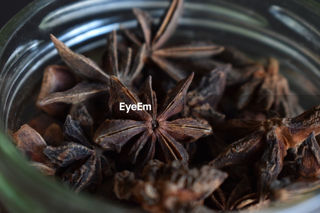 food and drink, food, star anise, spice, no people, ingredient, drink, close-up, indoors, healthy eating, freshness, wellbeing, selective focus, still life, herb, container, anise, dried food, large group of objects, abundance