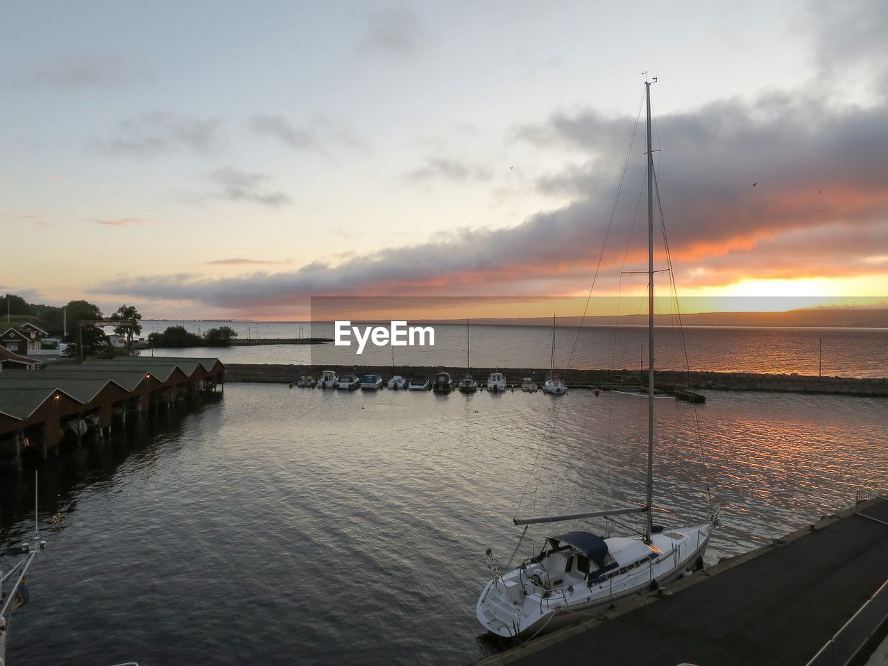 High angle view of boats moored at river during sunset