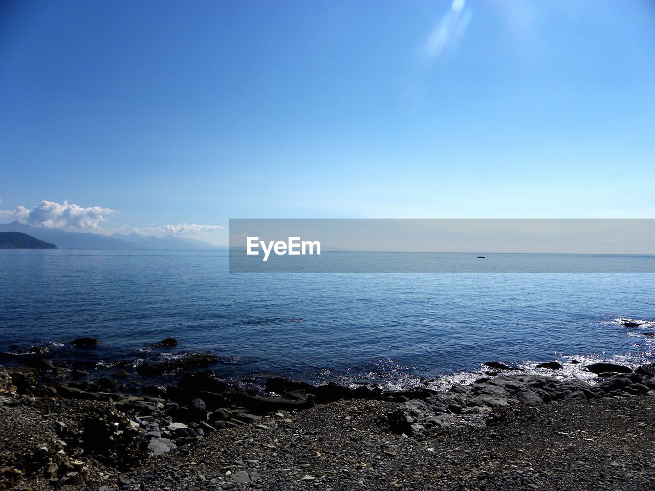 SCENIC VIEW OF BEACH AGAINST BLUE SKY