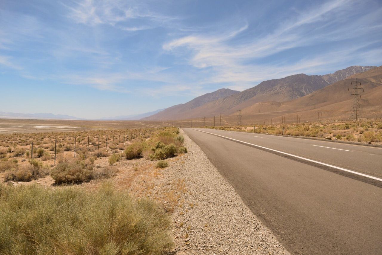 Empty road with mountains in background