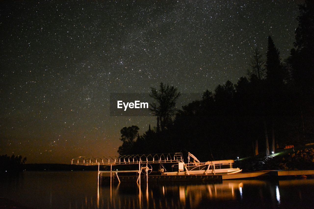 Low angle view of star field over lake