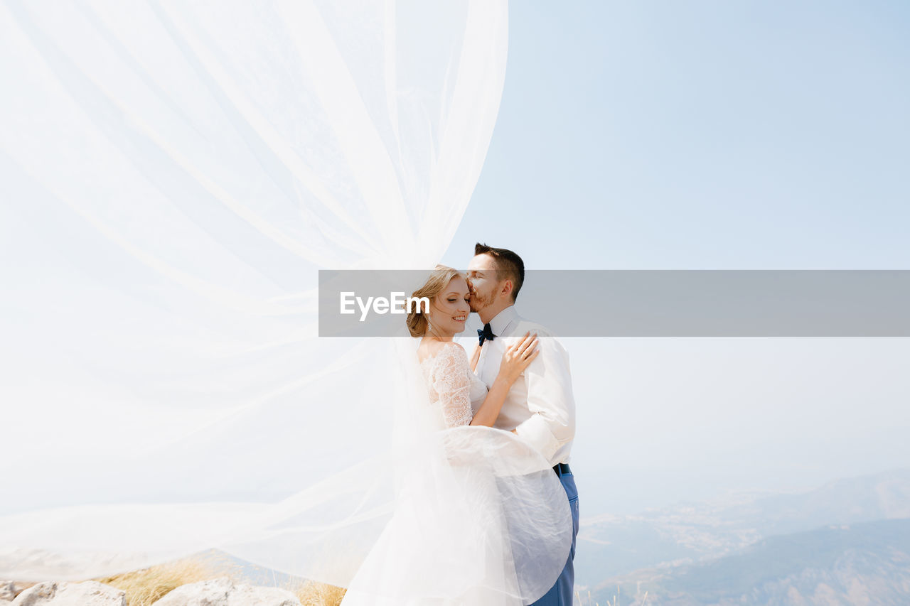 Young couple standing on field