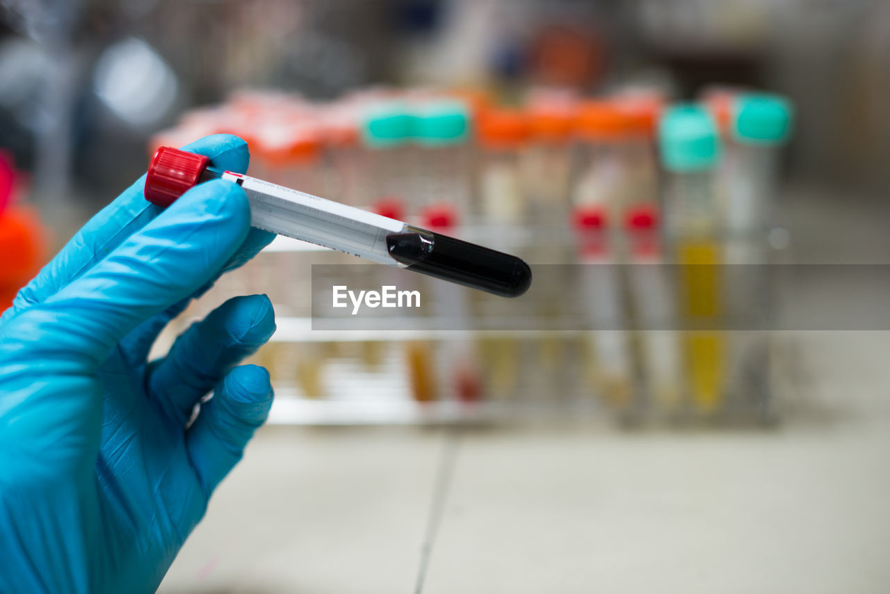 Cropped hand holding test tube in laboratory