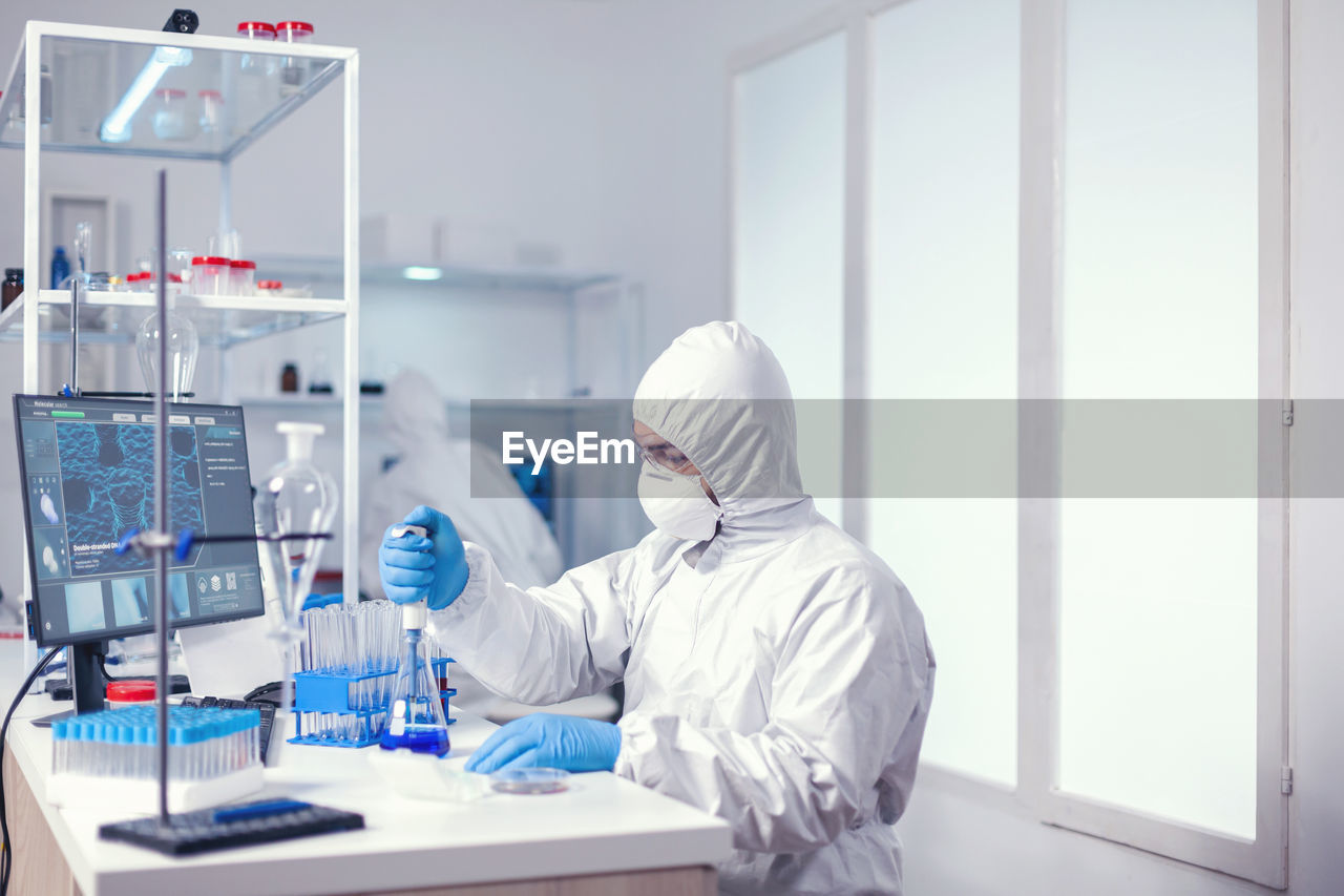 female scientist examining chemical in laboratory