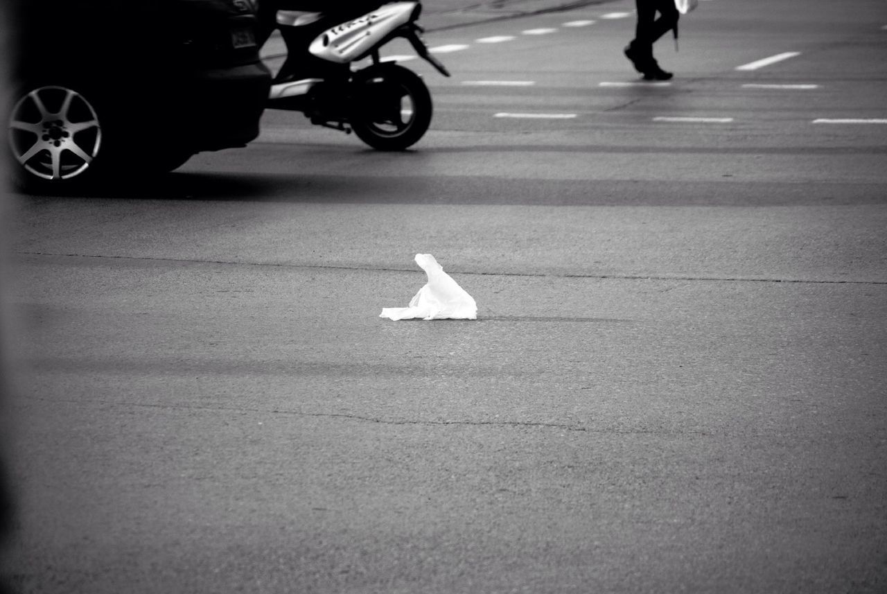 Cropped vehicles with white paper on road