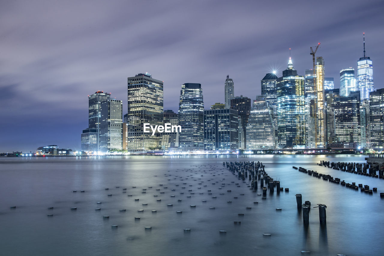 Manhattan glows across east river nyc