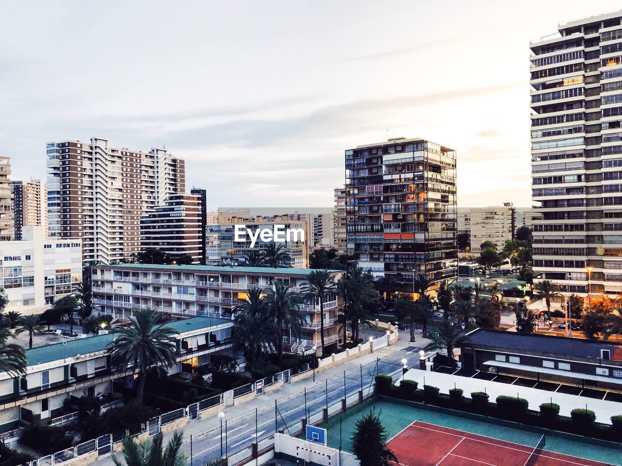 High angle view of street amidst buildings against sky