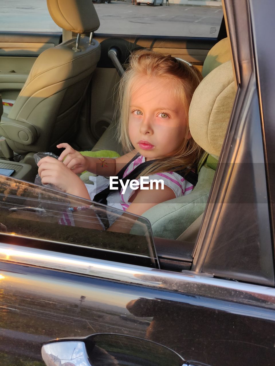 Portrait of girl sitting in car