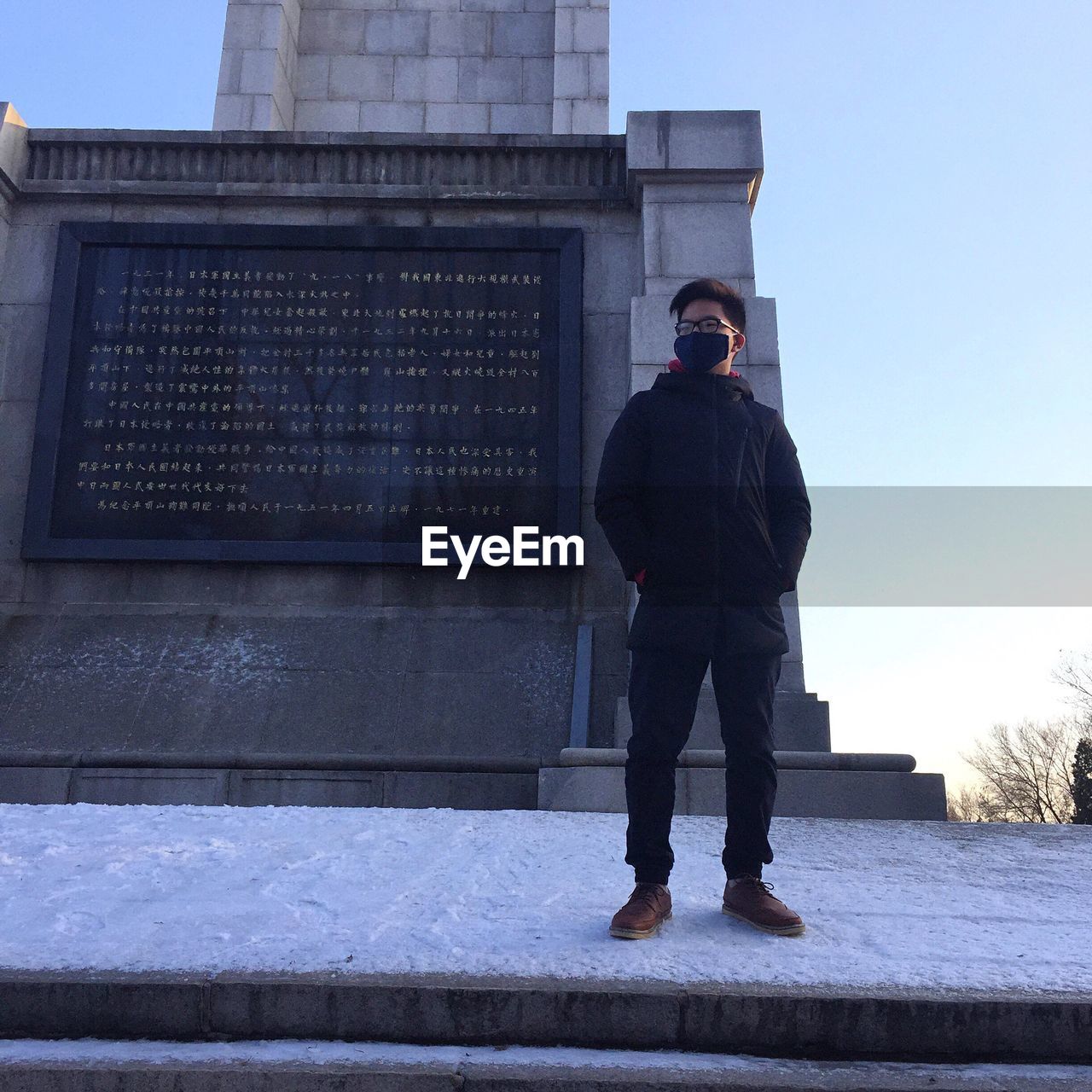 FULL LENGTH OF MAN STANDING ON COBBLESTONE