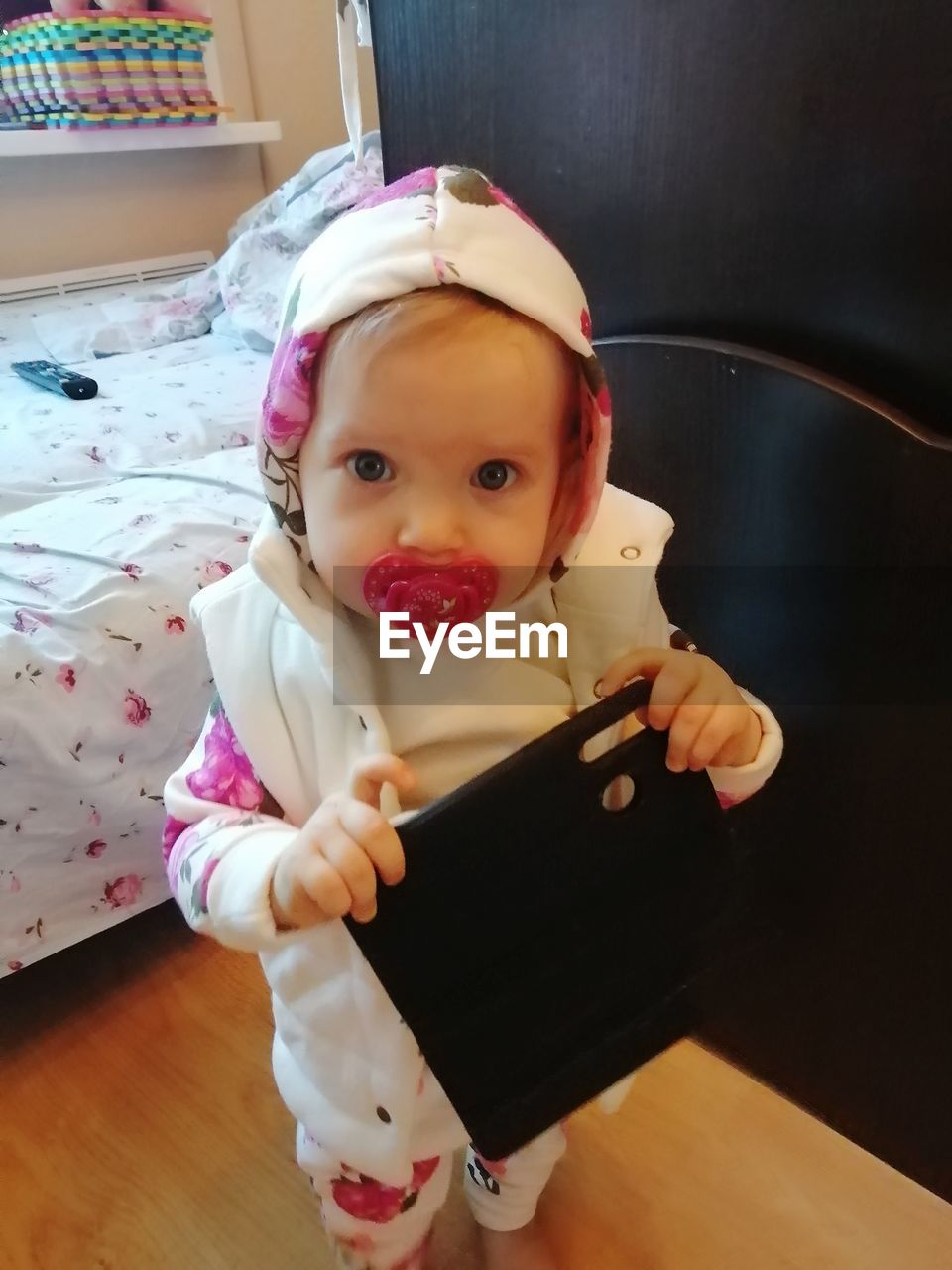 PORTRAIT OF CUTE GIRL WEARING HAT AT HOME