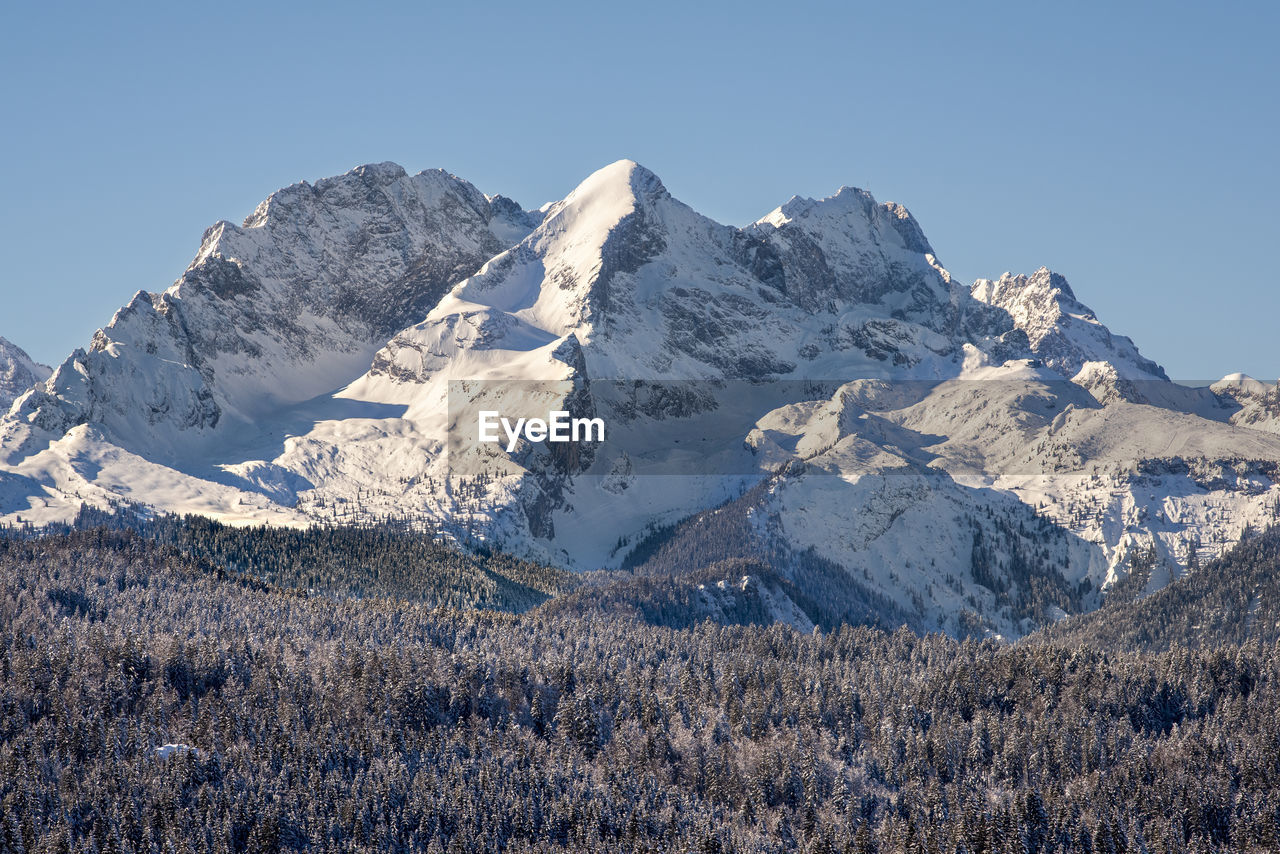 Scenic view of snowcapped mountains against clear sky