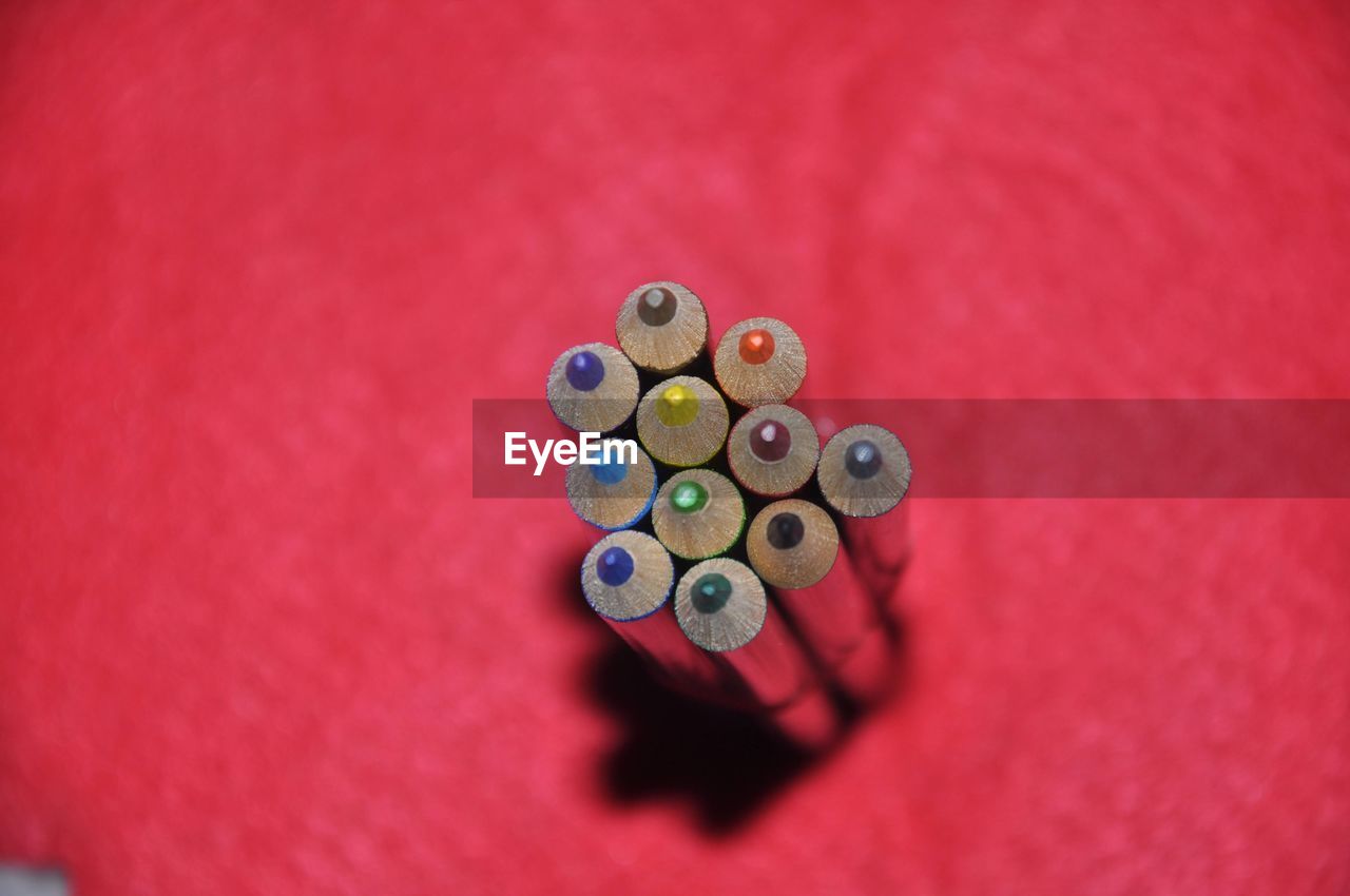 pink, indoors, high angle view, no people, close-up, red, large group of objects, macro photography, still life, circle, shape, bead, indoor games and sports