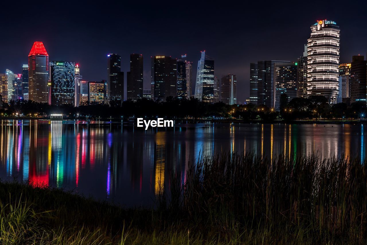 Reflection of illuminated buildings in city at night