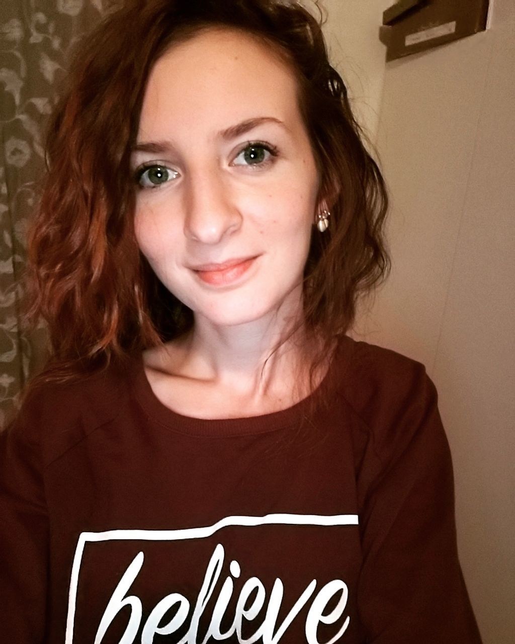 Portrait of redhead young woman at home