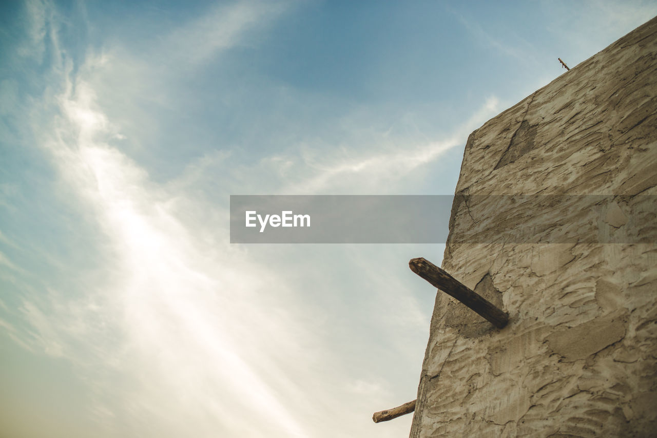 Low angle view of wall against sky