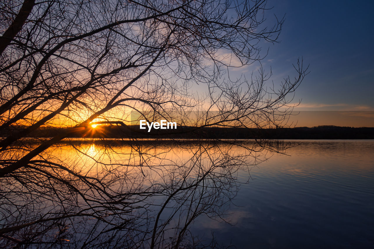 Scenic view of lake against sky during sunset