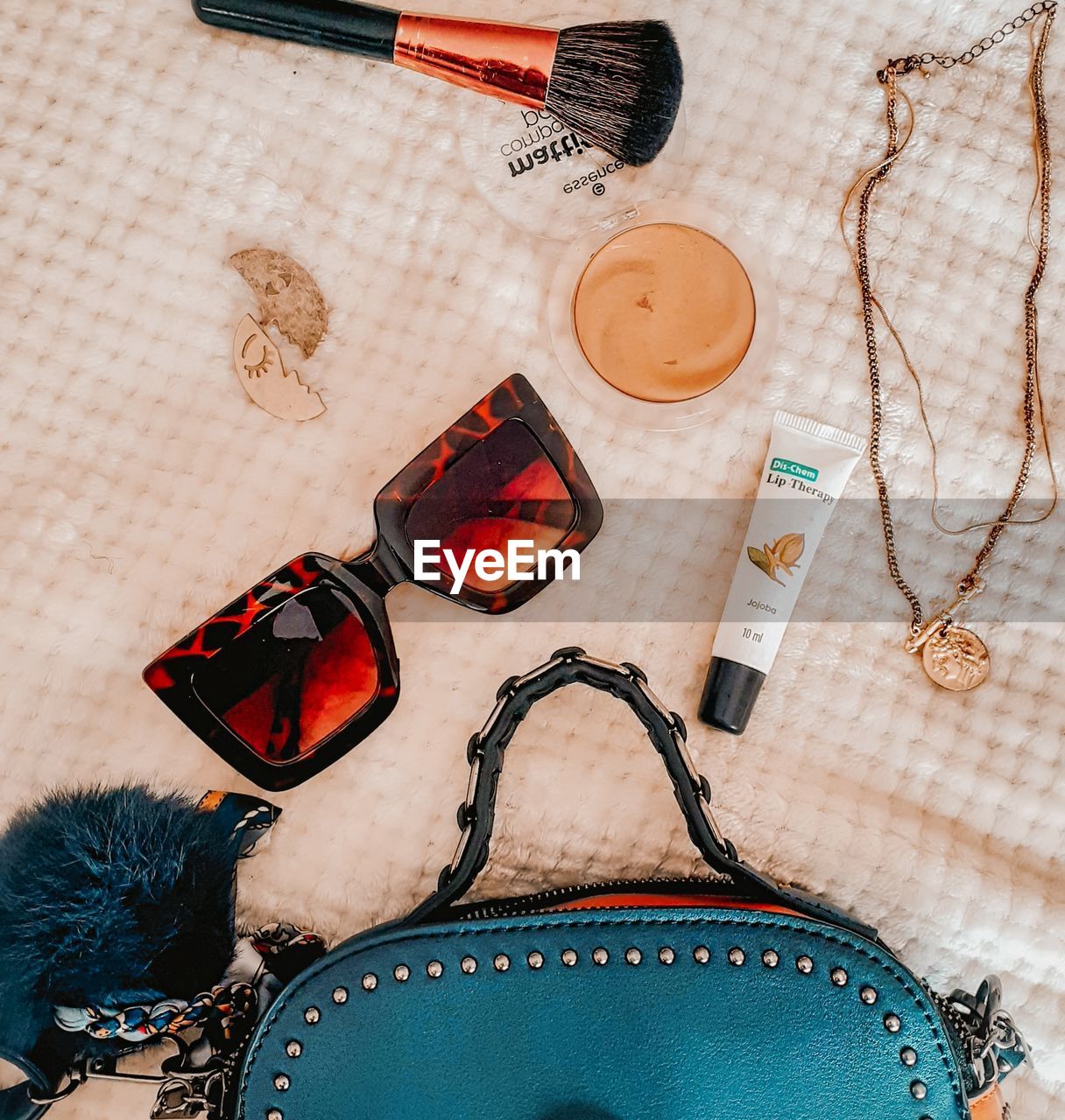 HIGH ANGLE VIEW OF SUNGLASSES AND SHOES ON WOODEN TABLE