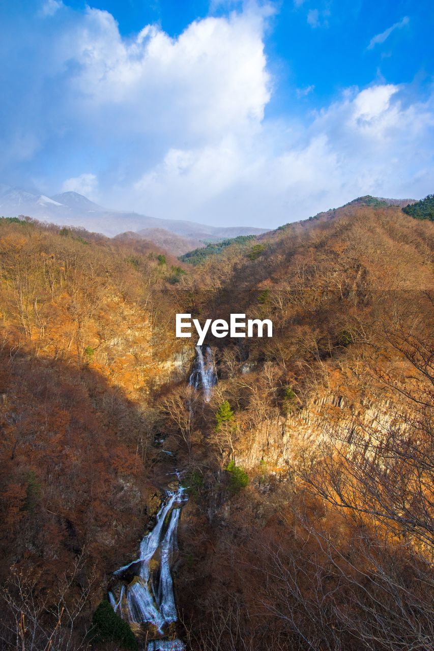 Water stream on mountain against sky