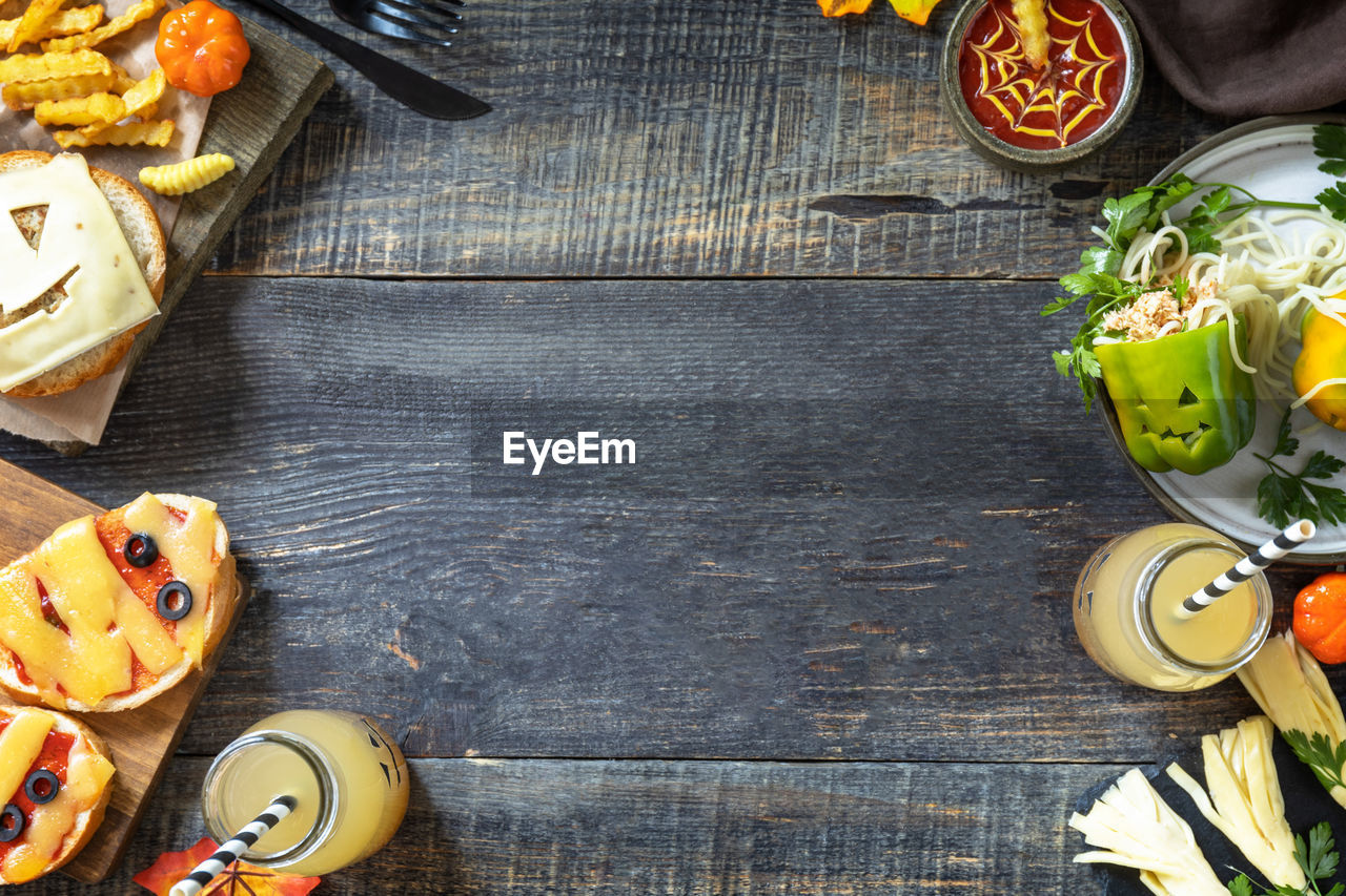 Halloween party food corner table scene over a wood background. 