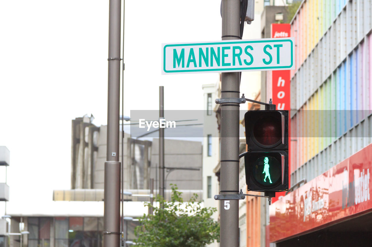 CLOSE-UP OF ROAD SIGNS AGAINST SKY