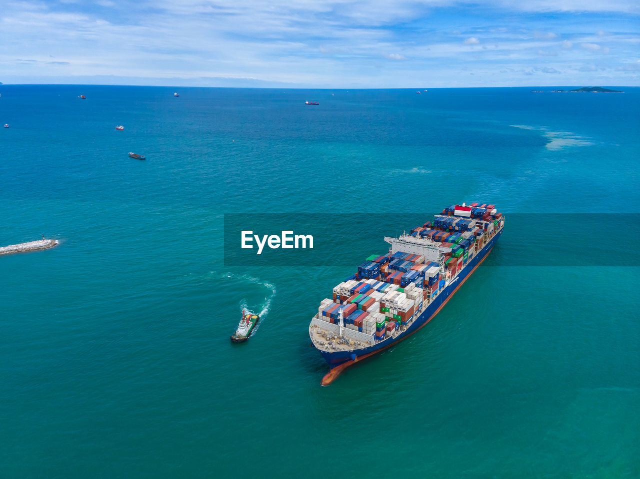 High angle view shipping containers sailing on the green sea