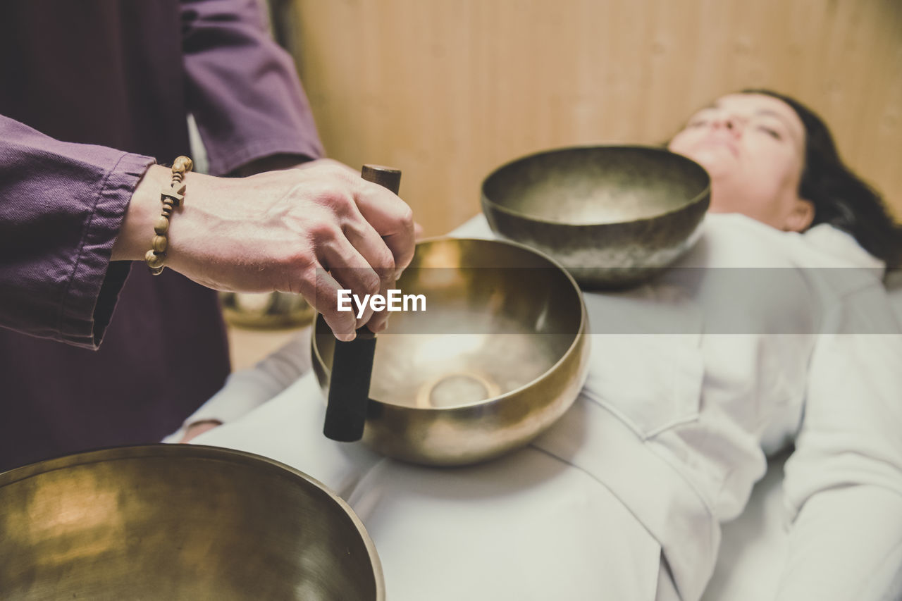 Woman practicing holistic activities with tibetan bells. meditation mindfulness exercises for calm