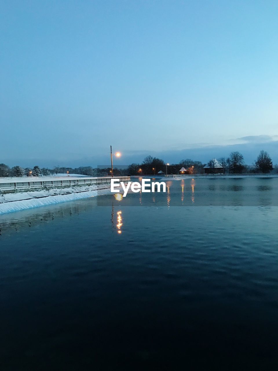 Scenic view of river against clear blue sky