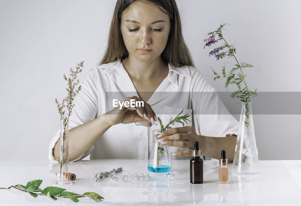 Woman working with cosmetic, scientist, doctor,  alternative herb medicine, organic in laboratory