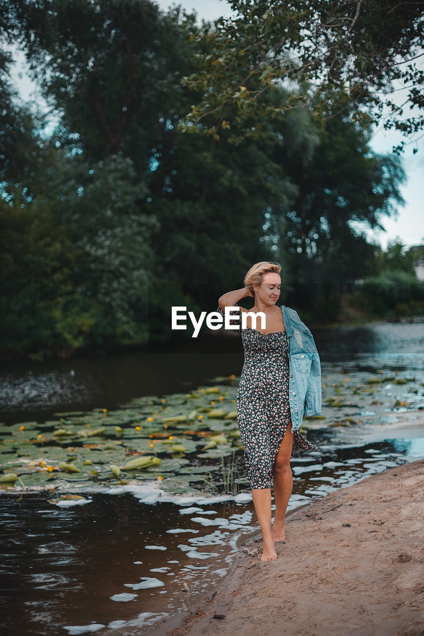 Rear view of woman standing in lake