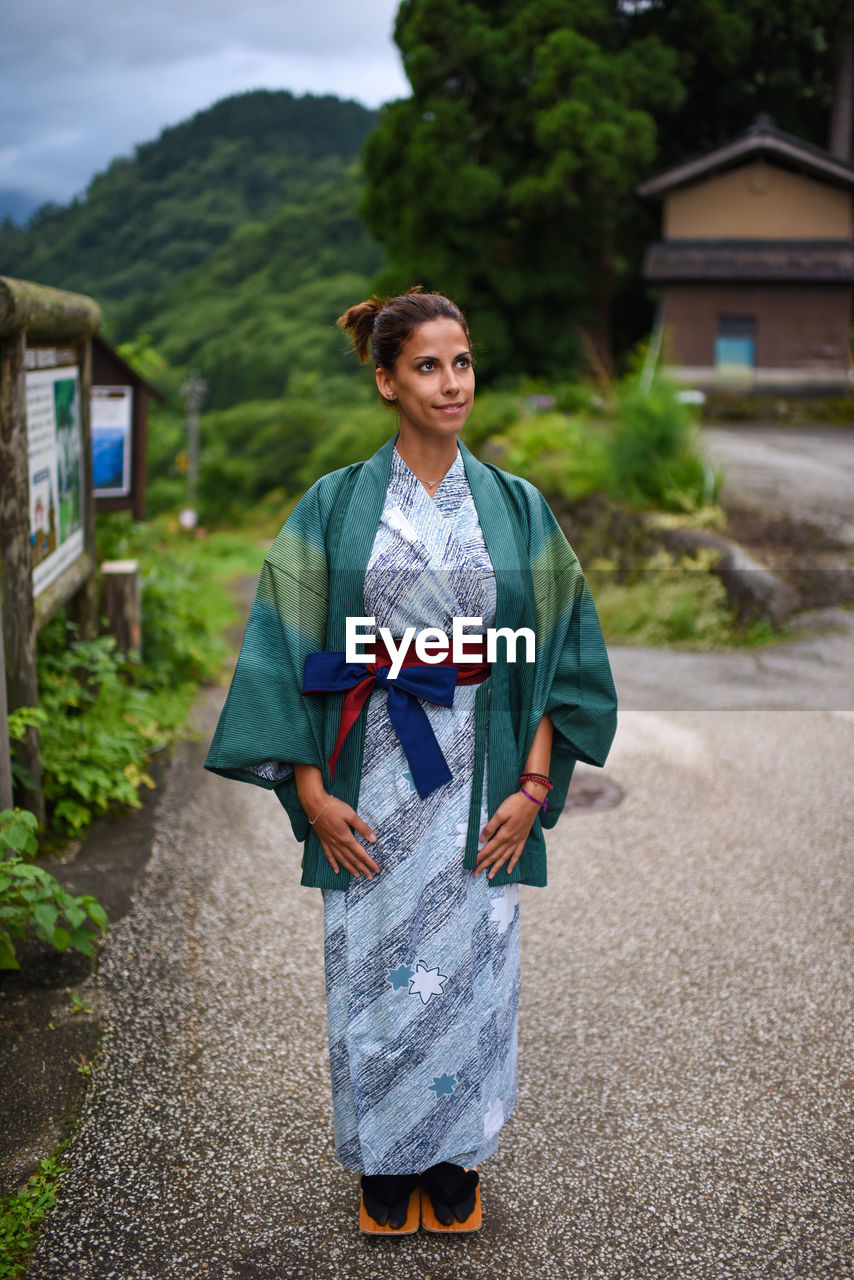 Portrait of contemplative young attractive caucasian woman wearing a traditional japanese kimono in the small village of ainokura, japan