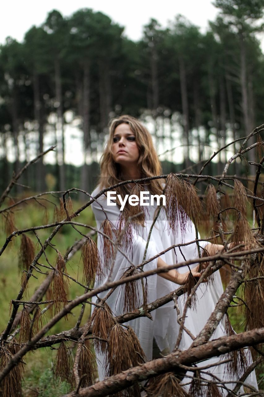 Portrait of young woman in forest