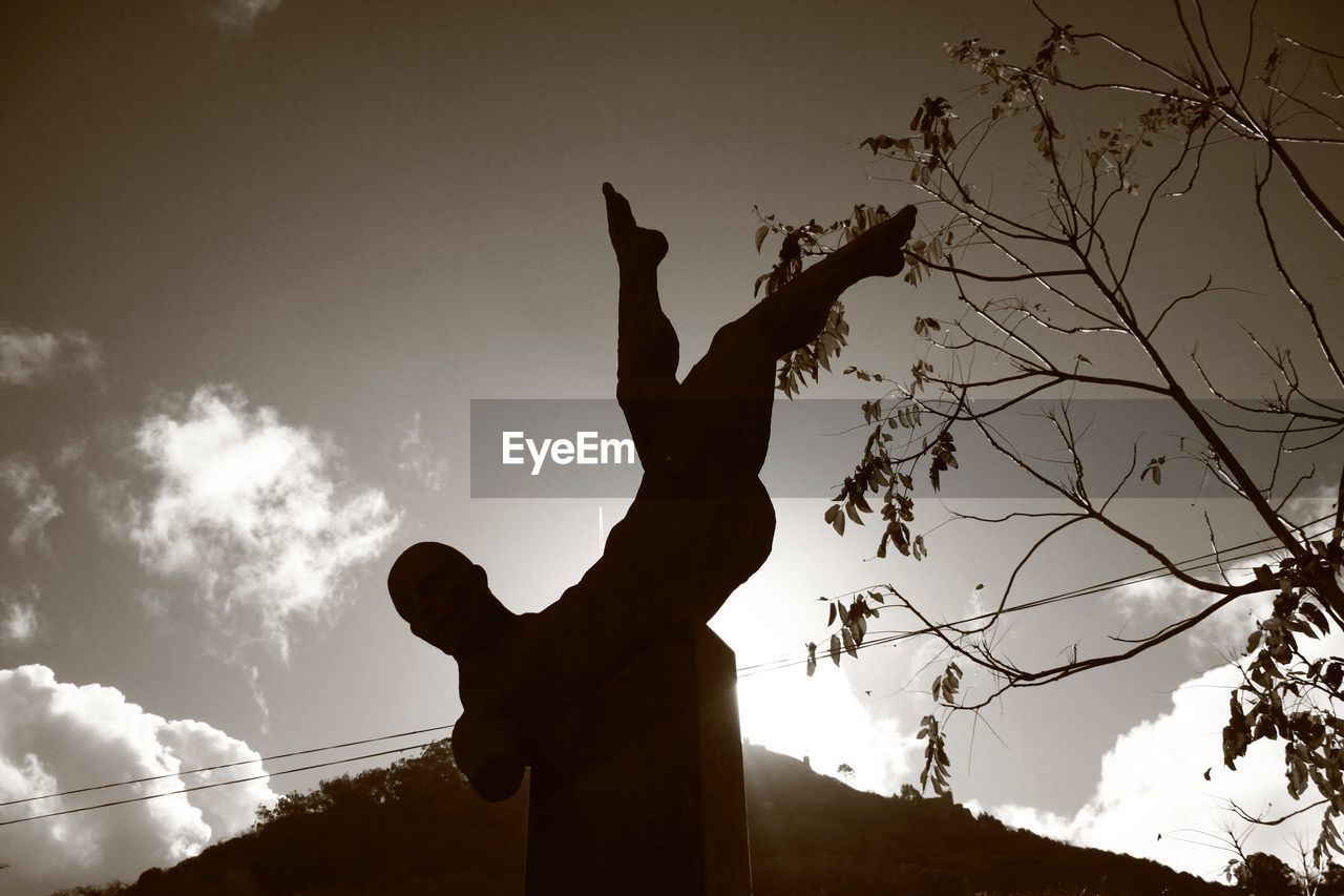 LOW ANGLE VIEW OF SILHOUETTE STATUES AGAINST SKY