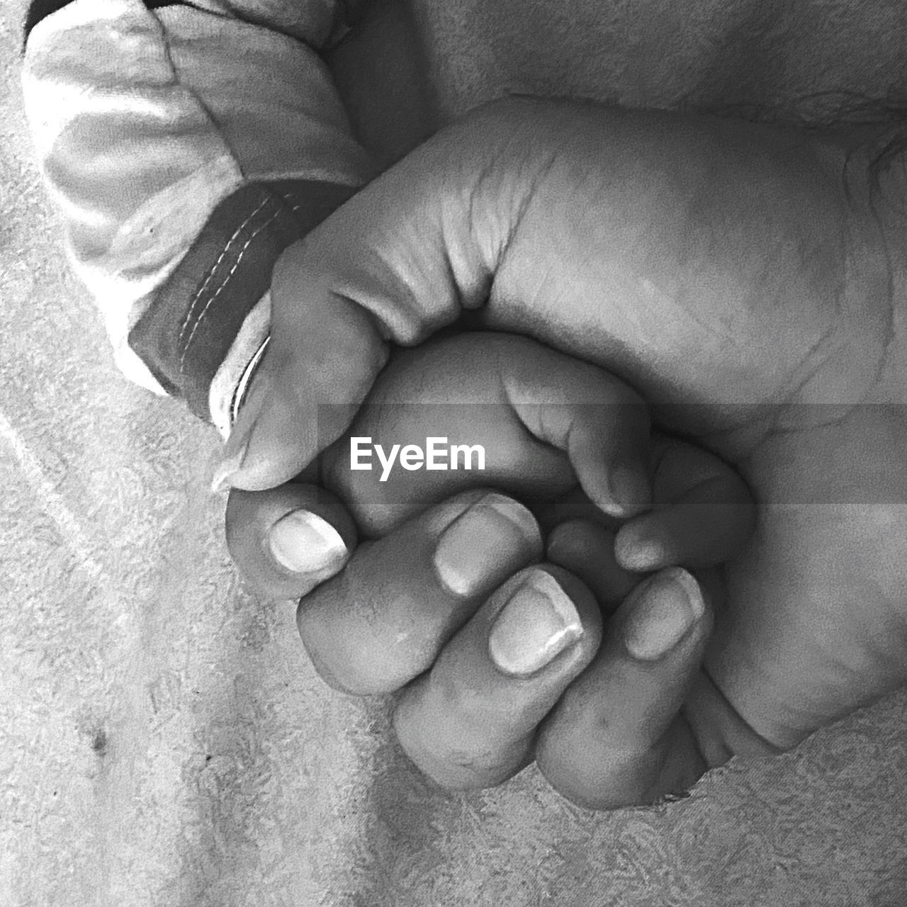 CLOSE-UP OF BABY HAND WITH TATTOO ON HANDS
