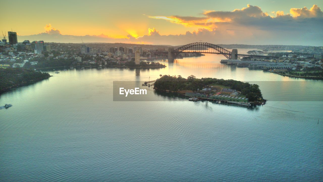 Scenic view of sea and buildings against sky during sunset