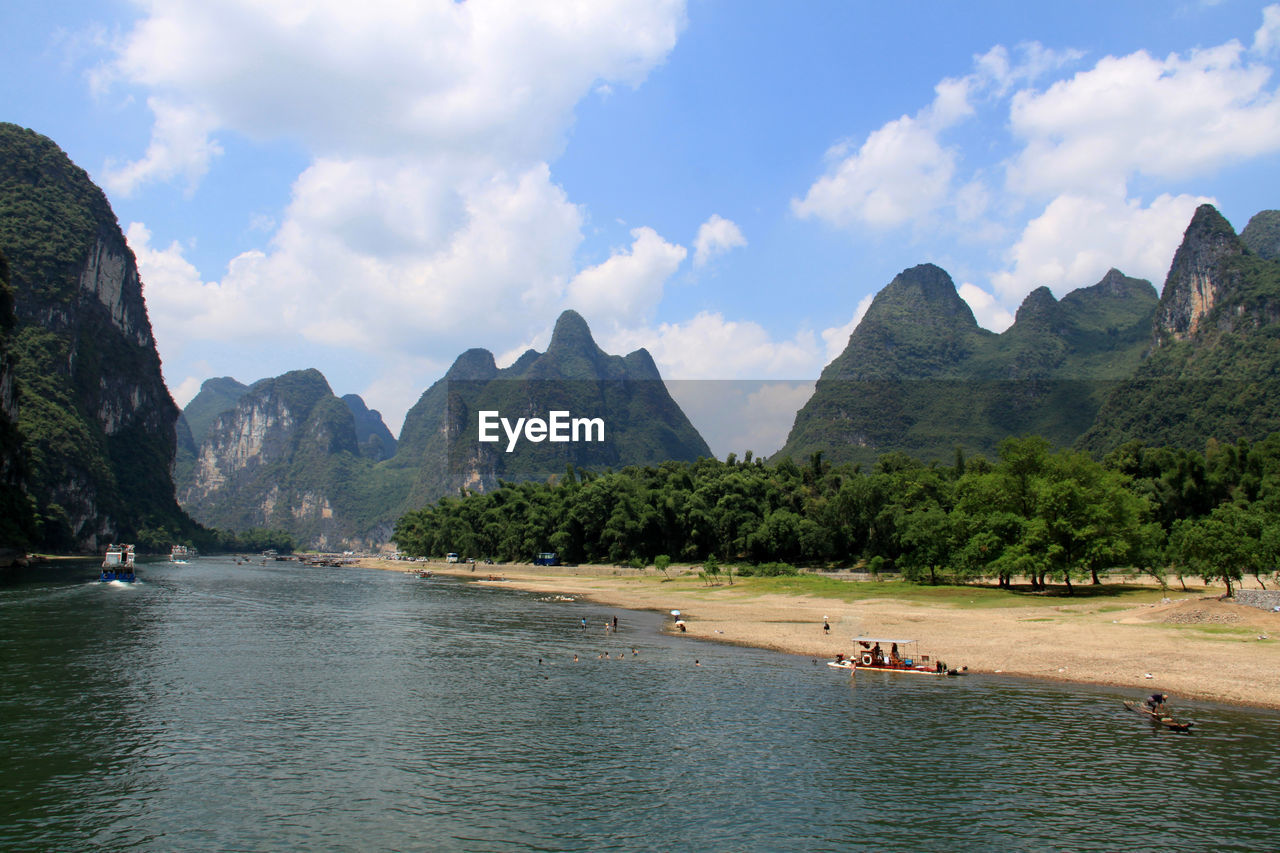 Panoramic view of sea and mountains against sky