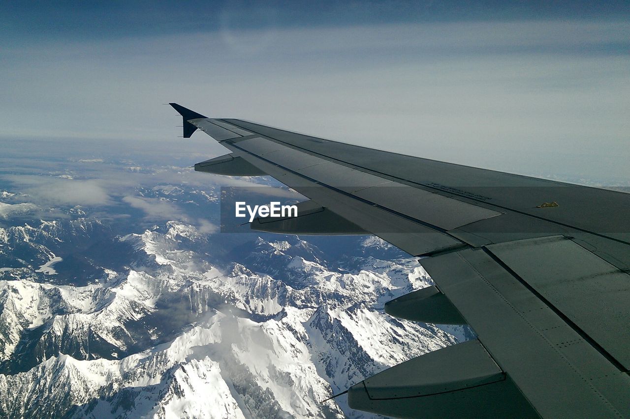 Cropped image of airplane flying in sky