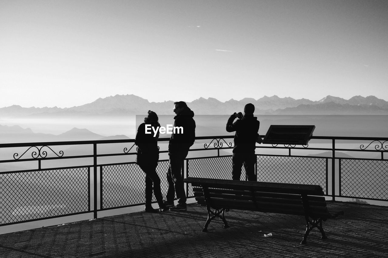 Rear view of people standing at observation point