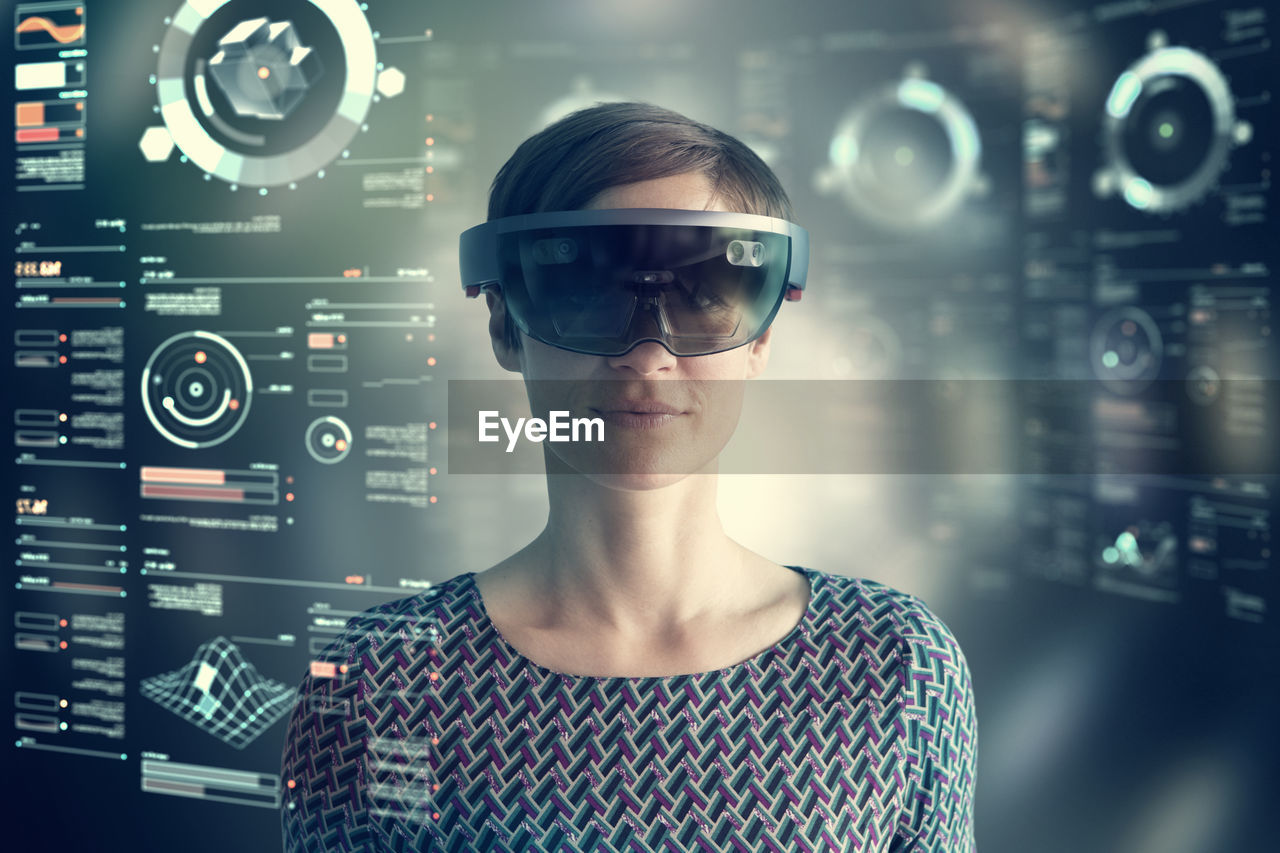 Woman wearing mixed reality smartglasses at transparent screen