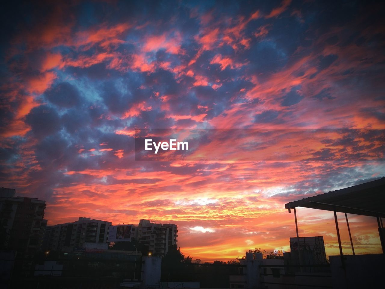 SILHOUETTE BUILDINGS AGAINST ORANGE SKY
