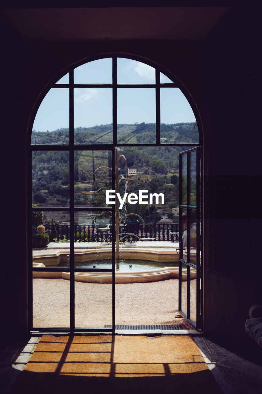 BUILDINGS SEEN THROUGH GLASS WINDOW