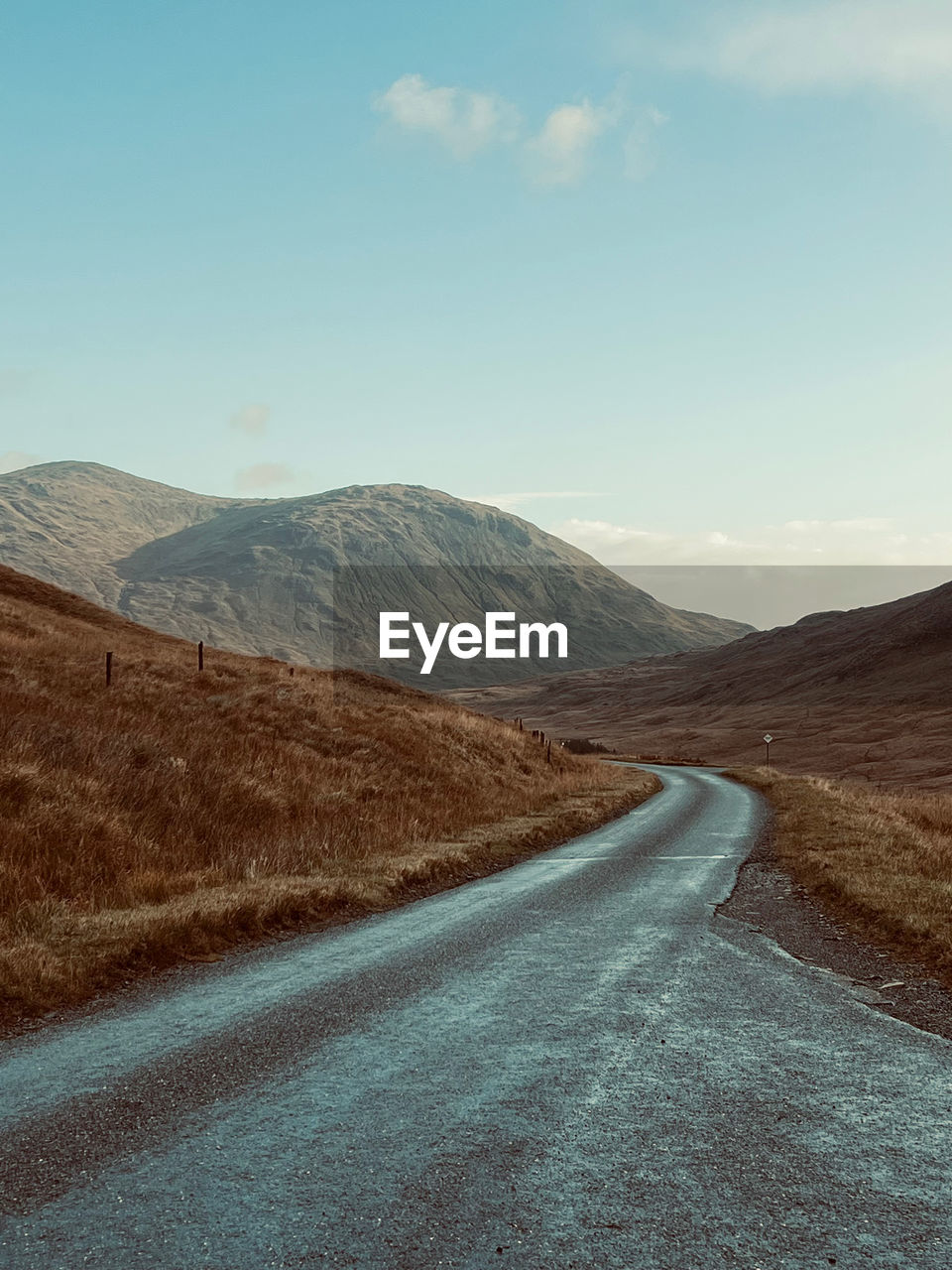 Road amidst mountains against sky