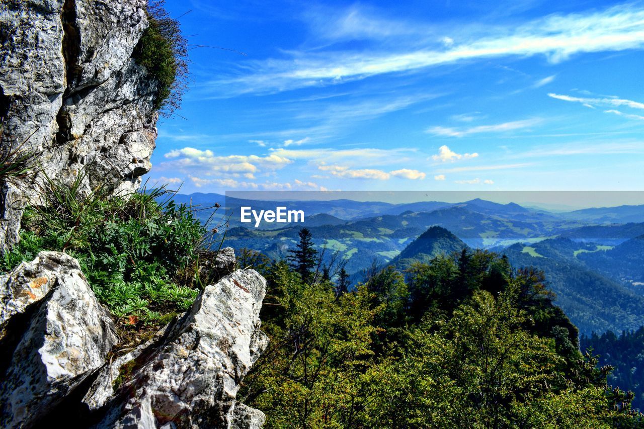 Scenic view of mountains against blue sky