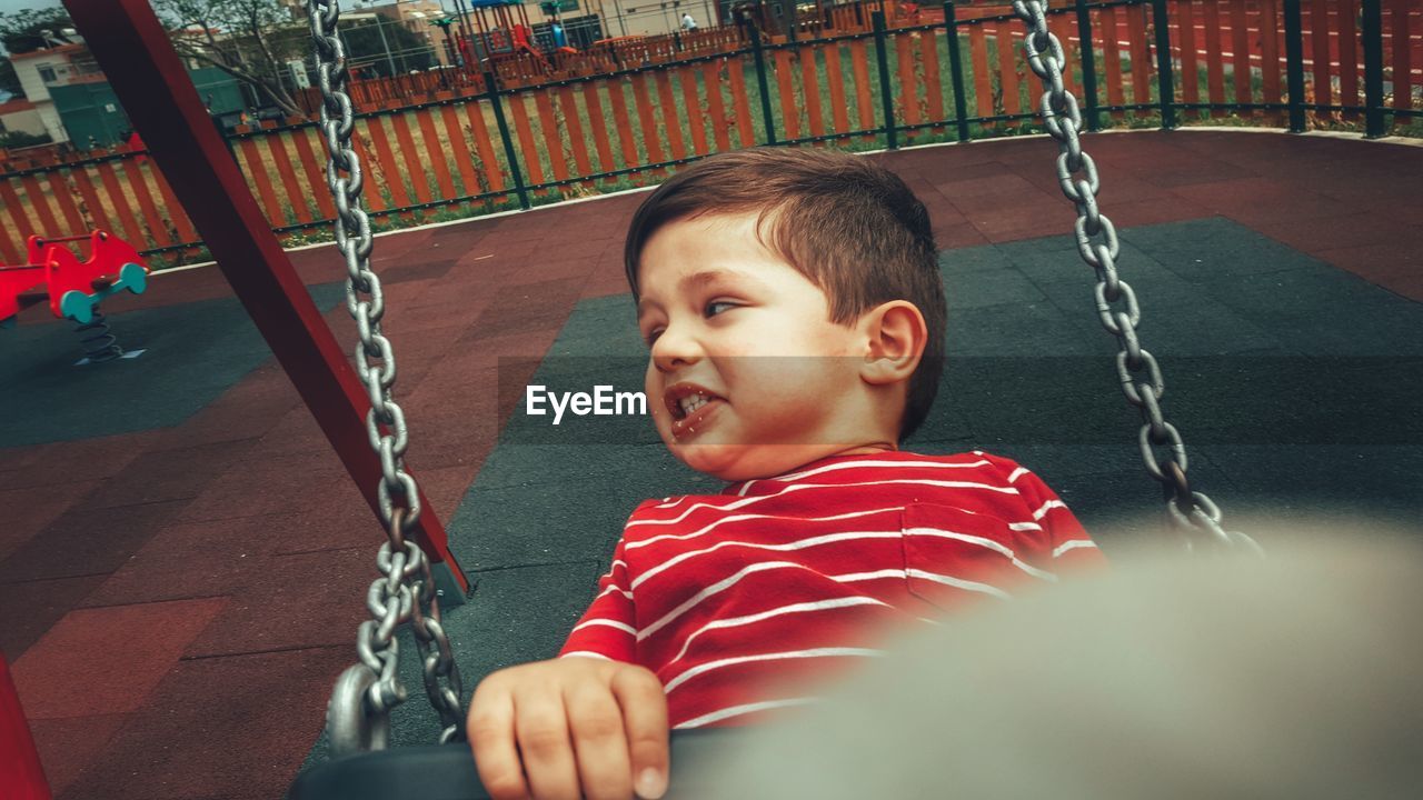 Portrait of young boy on swing